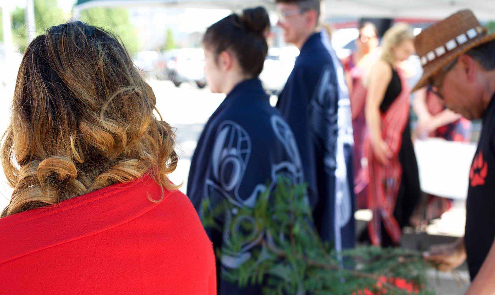 Youth who are aging out of care this year receive a cedar brushing at an honouring ceremony hosted by Métis Family Services in Surrey